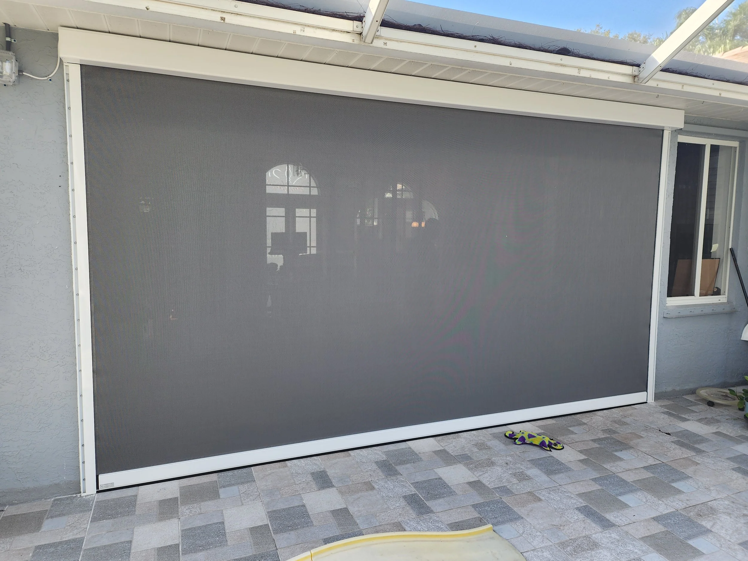 Retractable hurricane screen installed in patio home