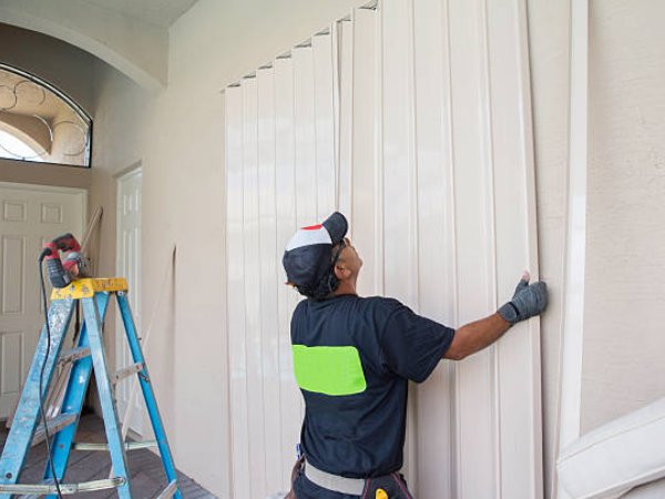 Team installing hurricane accordion shutters Melbourne home