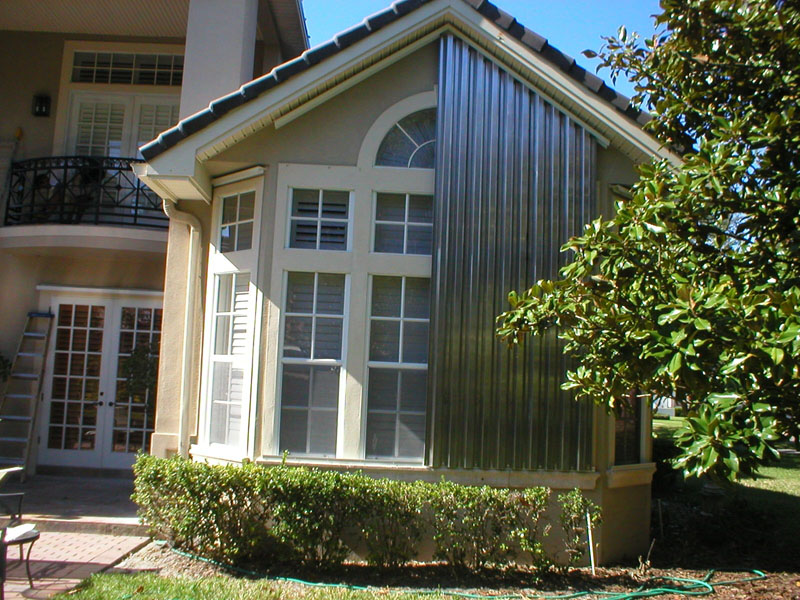 Impact windows and metallic storm panels house